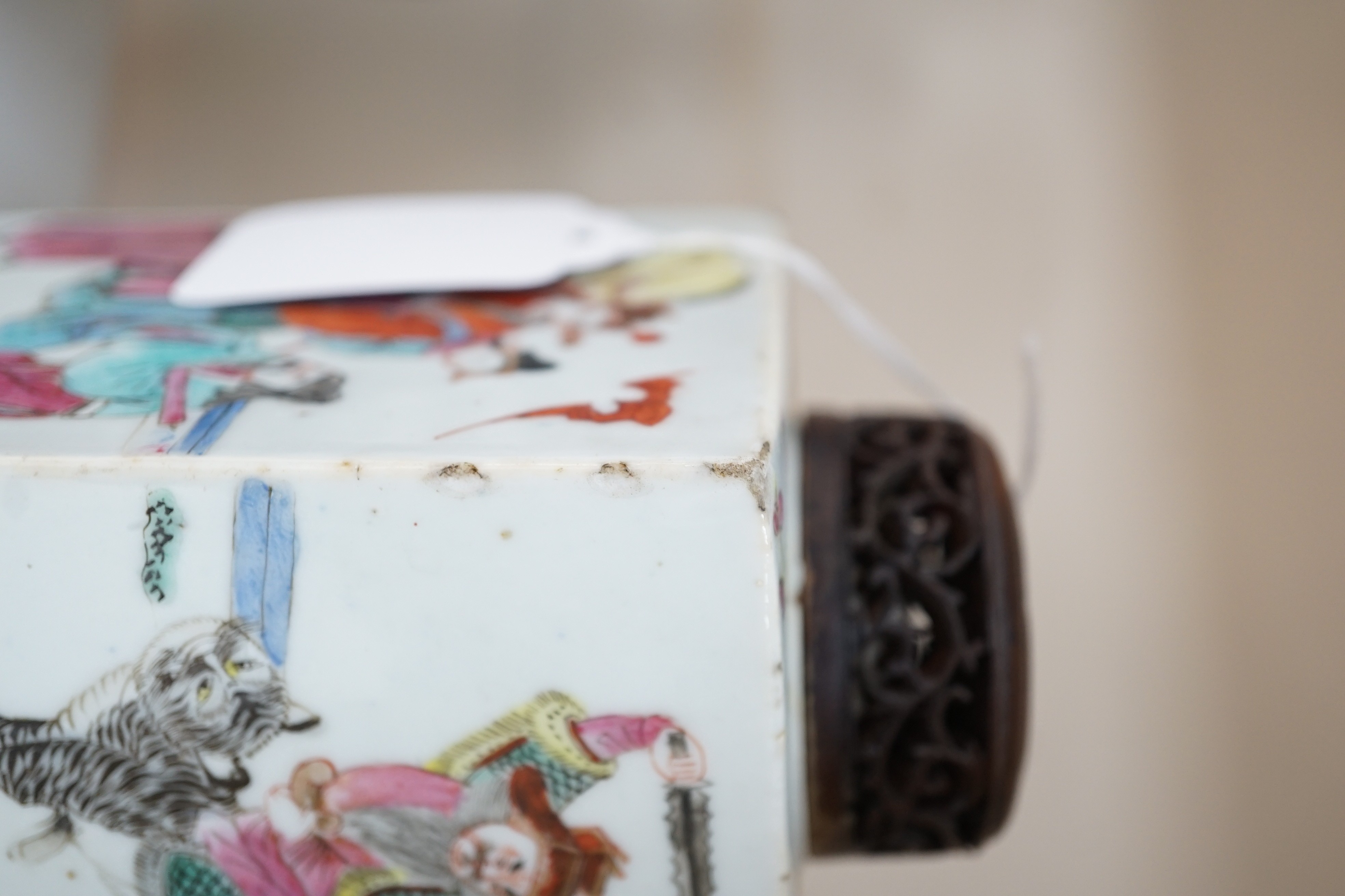 A Chinese famille rose square tea caddy, mid 19th century, 13.7cm high excluding wood stand and cover, slight damage